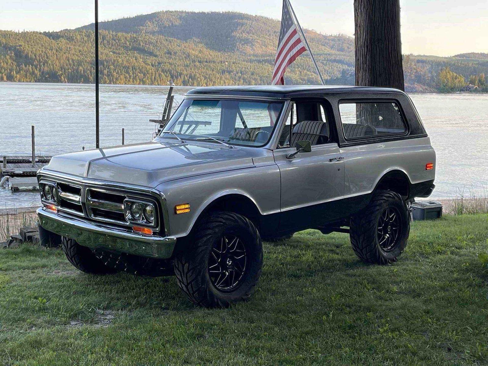 Patriot Chassis GMC Jimmy turn-key build with American flag at lakeside